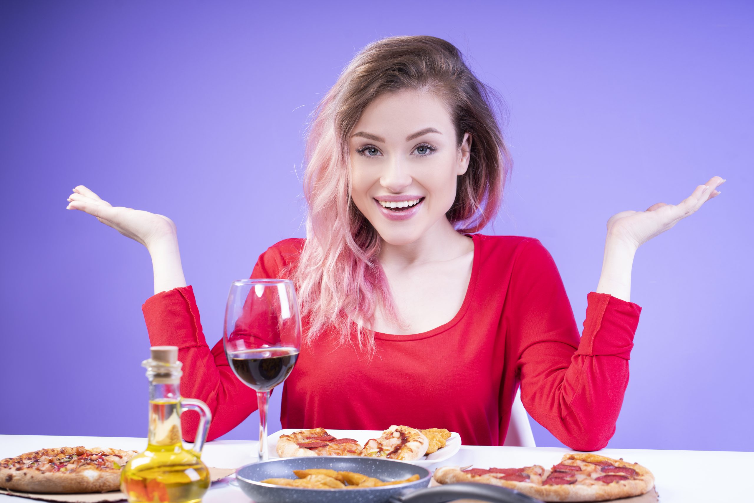 pink-haired girl spreading her arms to the sides looks at the camera